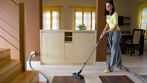 Woman in Yellow Shirt Vacuuming